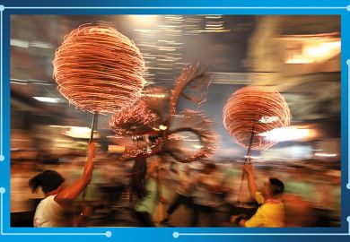 Members of the fire dragon dance team spin balls of joss sticks during the Tai Hang Fire Dragon Dance in Hong Kong. To illustrate Asian universities gathering momentum in the THE World University Rankings. Members of the fire dragon dance team spin balls of joss sticks during the Tai Hang Fire Dragon Dance in Hong Kong. To illustrate Asian universities gathering momentum in the THE World University Rankings.