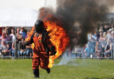 Man in hazard suit on fire