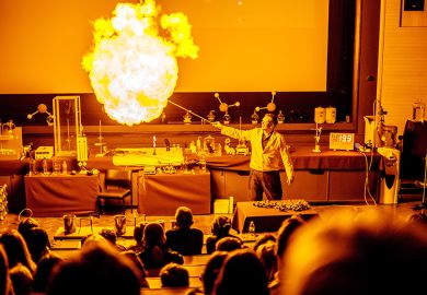 A lecturer with a fireball at the Cambridge Science Festival. To illustrate the precarity of teaching-only and temporary roles in universities as they bear the brunt of the UK jobs cull.