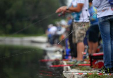 Many people fishing in the same river, representing a grants commons Many people fishing in the same river, representing a grants commons