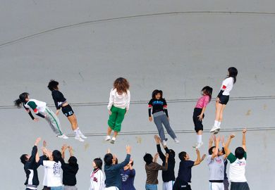 Chinese students throwing other students in air Chinese students throwing other students in air