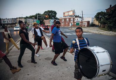 Children dancing in street, following a drummer