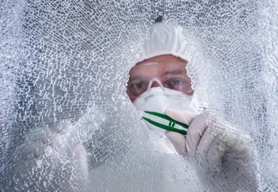 Forensic examiner inspecting broken shatterproof window