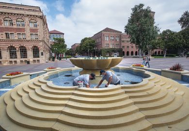 Men repair damaged tiles inside a fountain on the USC campus in Los Angeles Men repair damaged tiles inside a fountain on the USC campus in Los Angeles
