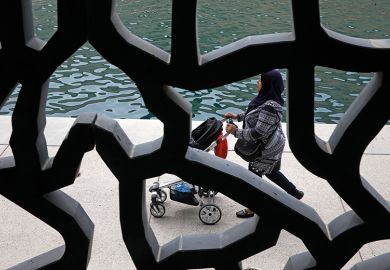 View from the MUCEM museum, Marseille, France, showing a woman pushing a pushchair. View is obscured - to illustrate how universities offer little evidence of their gender equality efforts