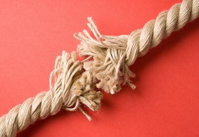 Frayed rope on red background