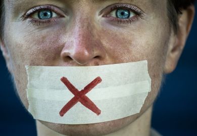 A woman with tape over her mouth symbolising free speech