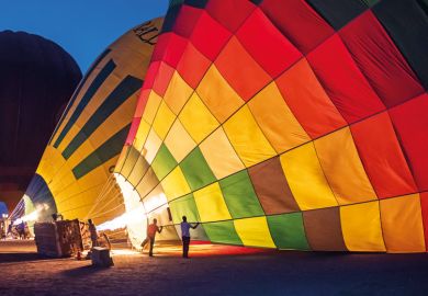 Gas burners filling hot air balloons at dawn Gas burners filling hot air balloons at dawn