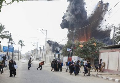 A bomb explodes in Gaza, illustrating the war's threat to academic freedom