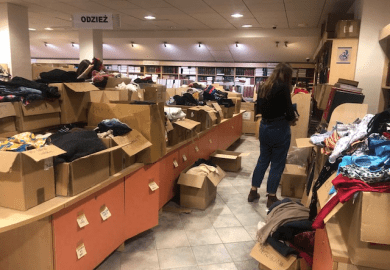 A woman sorts through donations for Ukraine at the University of Gdansk