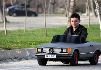 Man driving small car