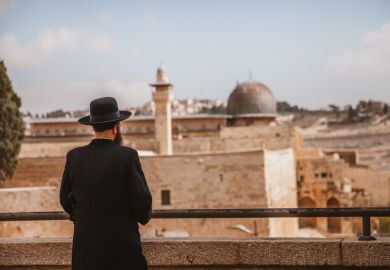 A Jewish man looking at the wailing wall in Jerusalem,Israel. A Jewish man looking at the wailing wall in Jerusalem,Israel.
