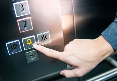 Forefinger pressing on emergency stop and alarm button in elevator Forefinger pressing on emergency stop and alarm button in elevator