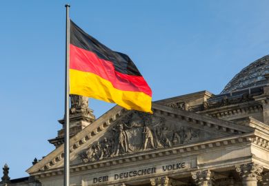  German flag fluttering in front of the Reichstag building in Berlin