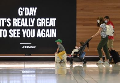 A family leave to board a plane at Sydney's International Airport 