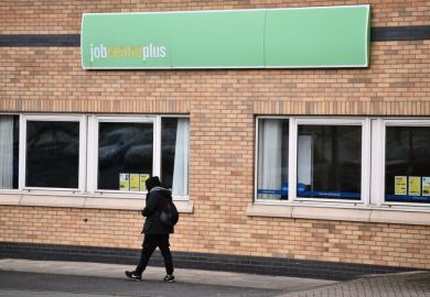 A man walks past a Jobcentre Plus employment office