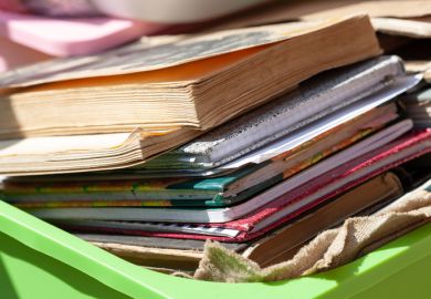  Lots of different old books and paper notebooks in a container