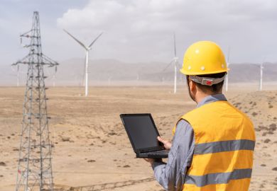Male engineer is working in wind power station 