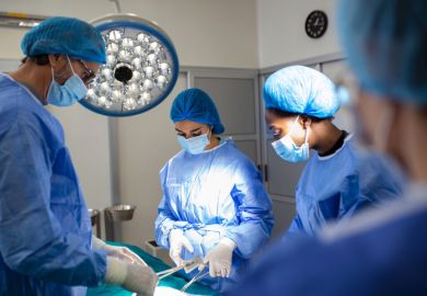 Group of surgeons in operating room with surgery equipment Group of surgeons in operating room with surgery equipment