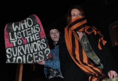 Protesters hold a placard at Cambridge University Union