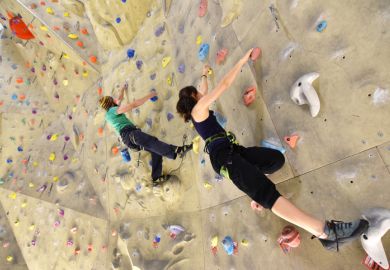 Young sporty climbers on a climbing wall Young sporty climbers on a climbing wall
