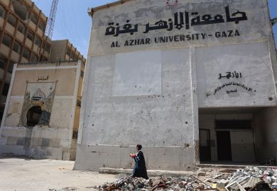 Palestinian researcher Nevin Yassin carries flowers as she walks past rubble after defending her Masters thesis at Al-Azhar University in in Gaza City on May 1, 2025 Palestinian researcher Nevin Yassin carries flowers as she walks past rubble after defending her Masters thesis at Al-Azhar University in in Gaza City on May 1, 2025