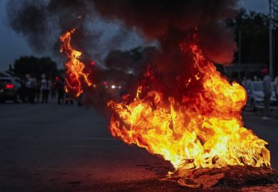 Burning tyres smolder on a road during a protest action, Burning tyres smolder on a road during a protest action,