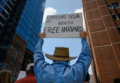 Harvard alumni, students and faculty protest the federal administration cuts outside of the Boston Moakley Federal District Courthouse
