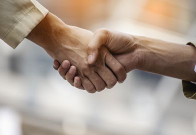Two people shaking hands Two people shaking hands