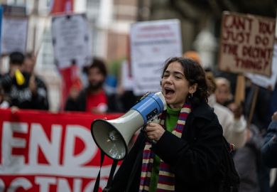 Striking cleaners hold a noisy early morning march around the buildings and halls of residence at UCL