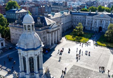Aerial view of Trinity College Dublin showing a tower in the centre with historic buildings around it