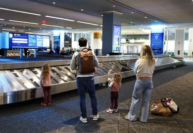 A family waits at baggage claim at LaGuardia Airport in New York on February 22, 2026