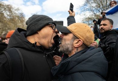 Two opposing side facing off by shouting at each other during a rally in London