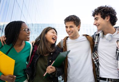 Group of cheerful students walking and laughing together outside Group of cheerful students walking and laughing together outside
