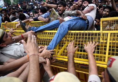 Activists and supporters of the Cockroach Janta Party (CJP) clash with police personnel during a protest demanding the resignation of India's education minister Dharmendra Pradhan