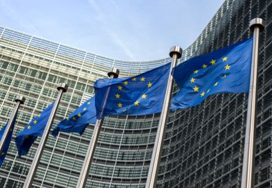 European flags waving in the wind side by side in front of the Berlaymont building