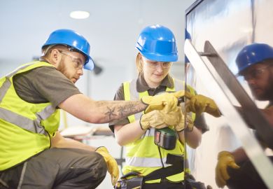 Female construction apprentice and colleague 