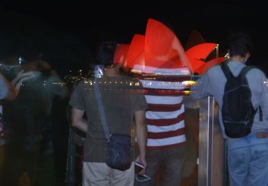 This long exposure photograph shows Chinese tourists taking photos in front of the Sydney Opera House which is lit up red to welcome in the Lunar New Year of the Monkey in Sydney on February 8, 2016.