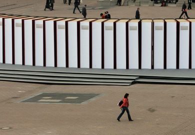 Visitors walk past giant books at the Frankfurt Book Fair. Germany Visitors walk past giant books at the Frankfurt Book Fair. Germany