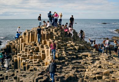 Crowd of people on the Giant's Causeway, Northern Ireland, illustrating how students may still look elsewhere to study if the Maximum Student Number (MaSN) cap was relaxed.