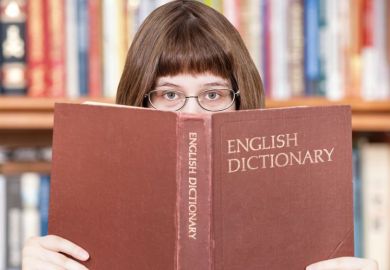 Girl looking over dictionary