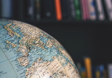 a globe with books in the background