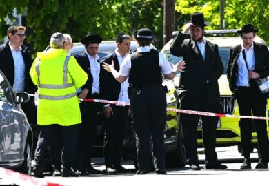  Local residents look on from outside a cordoned off area in the Golders Green neighbourhood of north London on April 29 following the stabbing to two people nearby. 