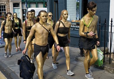 People with gold spray paint on their bodies
