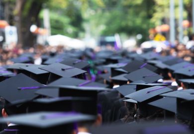 A line of graduates proceeding into a blur, illustrating uncertain prospects