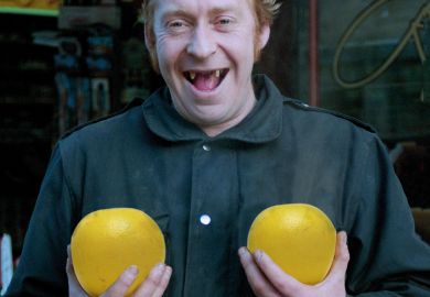 Man holding pair of grapefruit
