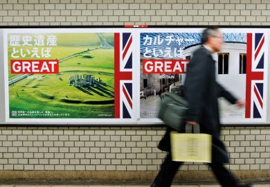 Pedestrian walks past 'GREAT' campaign posters Pedestrian walks past 'GREAT' campaign posters