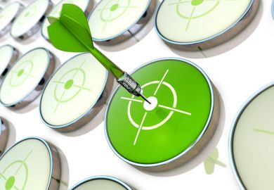 A green dart hits a target