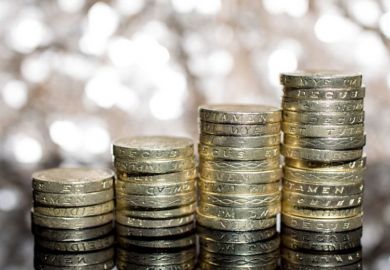 Growing piles of British pound coins