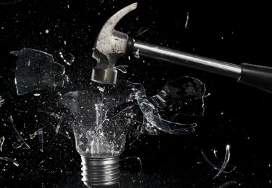 A hammer smashes a lightbulb